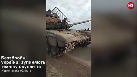 The Ukrainian Townspeople of Koryukivka Block Russian Tanks