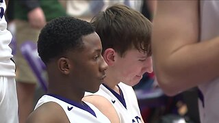 Barberton High School basketball player sits during national anthem for religious beliefs