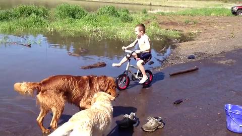 A Young Boy Rides A Bicycle Into Water