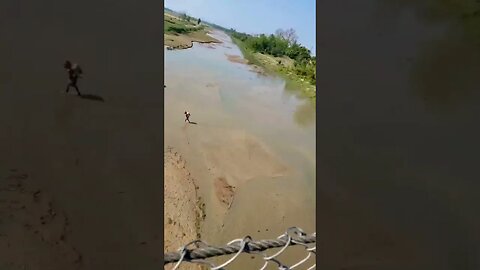 Driving a Royal Enfield across a swinging bridge in far-western Nepal