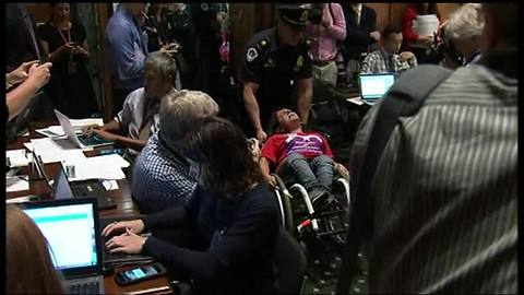 Protester removed from health care bill committee meeting