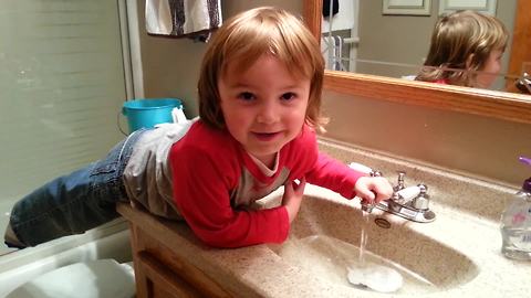 Funny Kid Drinks Water From The Bathroom Sink