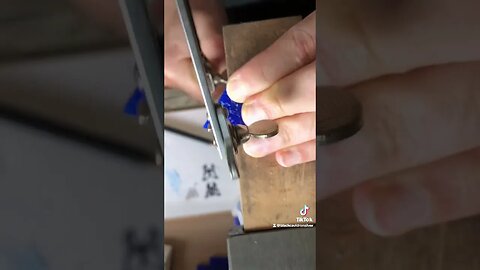 Hand carving a butterfly earring.