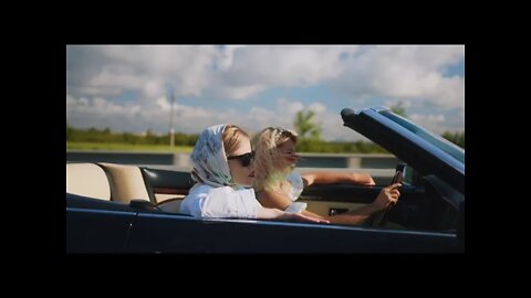 Two Women Riding a Car and Having Fun