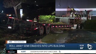 Semi-truck rolls away, crashes into building
