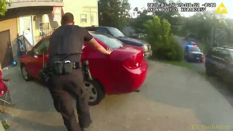 Body camera video shows a child in the backseat of a car while a policeman is firing at a suspect