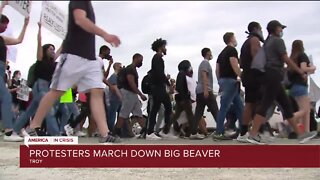 Protesters march down Big Beaver in Troy