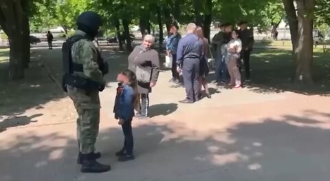 Little Ukrainian girl gives a Russian soldier a hug