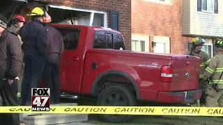 Truck crashes into Lansing area home