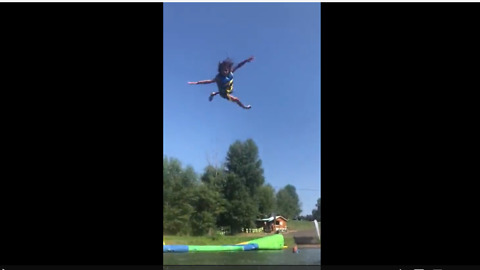 Kid goes soaring into air from inflatable water catapult