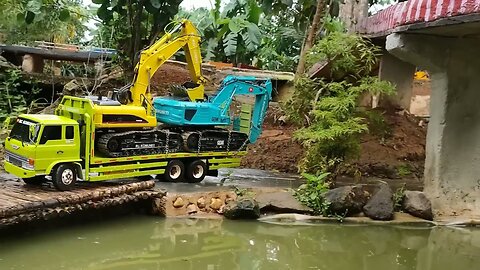 container remote control truck transporting excavator