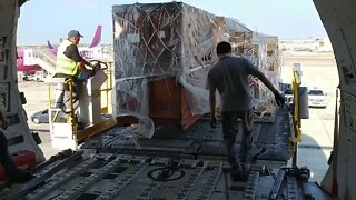 Unloading a long cargo container out of a B747-400