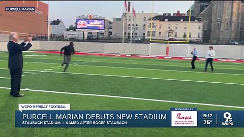 Roger Staubach throws with Purcell Marian football players ahead of Staubach Stadium debut