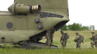 U.S. Army Paratroopers Jump from Chinook Helicopters