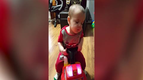 Tot Boy Sleeps On A Fire Truck Toy