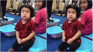Little girl can't get enough of a vibrating exercise board!