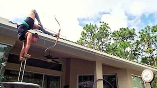 Woman dominates bow and arrow with her feet