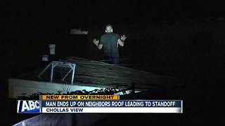 Man arrested after standoff on roof of home