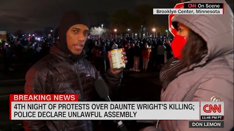 Protestor Winks At Camera As He Shows Off Can of Soup, Used as Weapon to Throw at Police
