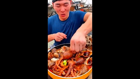 Chinese fishermen cooking and eating fresh sea food
