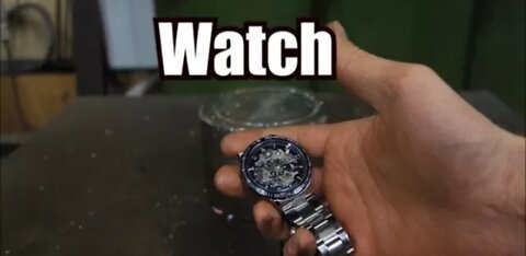 Crushing watch with hydraulic press.