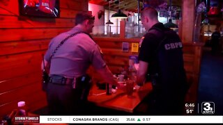 Iowa law enforcement officials service guests at Texas Roadhouse to benefit Special Olympics
