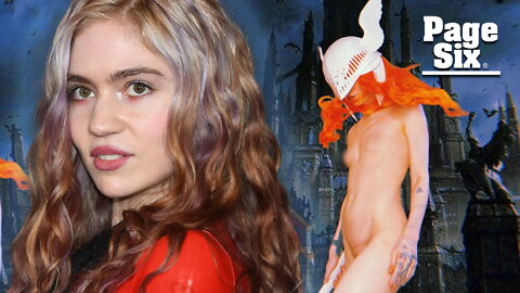 Grimes poses nude with mask and sword in delayed look at Halloween costume