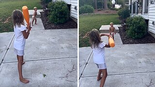 Sister accidentally smacks brother in the face with baseball