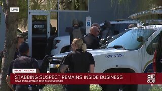 Stabbing suspect remains inside business