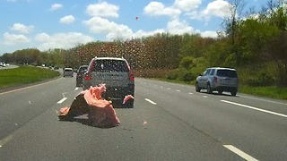 Truck loses some of his load on the highway