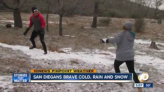 San Diegans brave cold, rain and snow