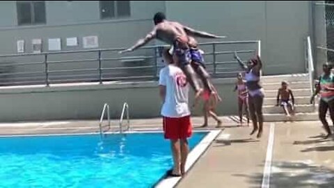 Young man jumps over lifeguard