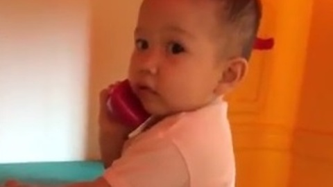 Baby "talking" on the phone will brighten your day!