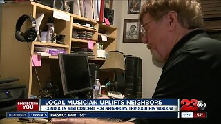 Local Musician uplifts neighbors with mini concert through his window