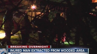 Crews rescue a man stuck in the woods in Akron