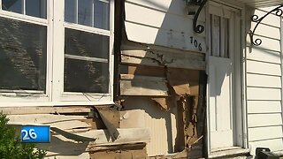 Truck drives into house