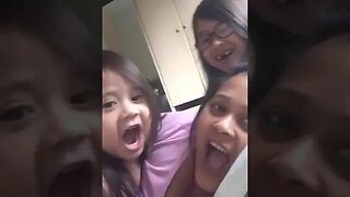 Cute mommy and her baby girls get ready for a selfie