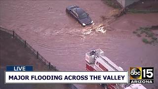 Vehicle stuck in flooded roadway in Phoenix
