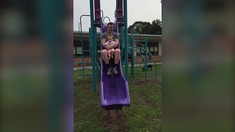 A Tot Girl Goes Down A Slide For The First Time