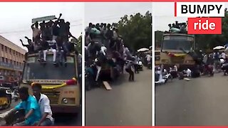 Kids celebrate by jumping on top of bus