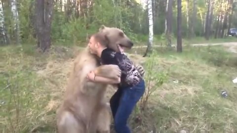 man playing with a bear