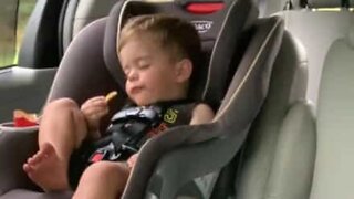 Boy can't decide between eating or sleeping!