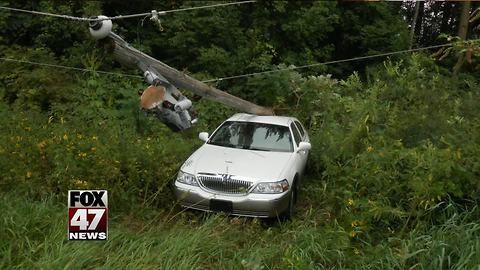 Woman hits gas instead of brake, gets stuck under electric pole