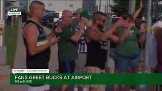Fans welcome home the Milwaukee Bucks as they fly into Mitchell Airport