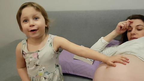 Little Girl Reacts to Baby Moving in Pregnant Mommy's Tummy