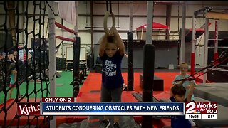 Ninjas-in-training conquering obstacles with new friends