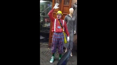 A clown in the street laughs young and old partie 2