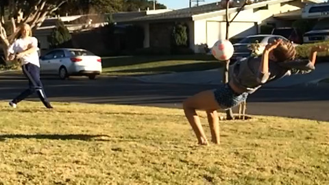 A Girl Flips Into A Soccer Ball To Her Face