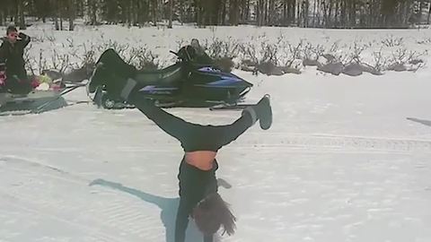 A Young Girl Does Several Cartwheels In A Row On The Snow