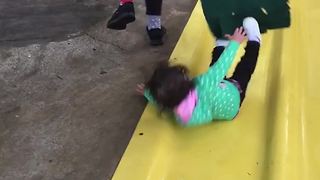 Girl Pulls Bag Out From Under Kid And She Falls On Slide